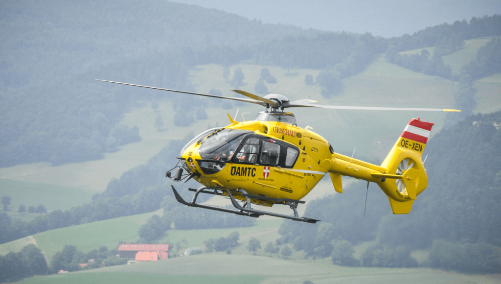 helicopter flying in mountain range